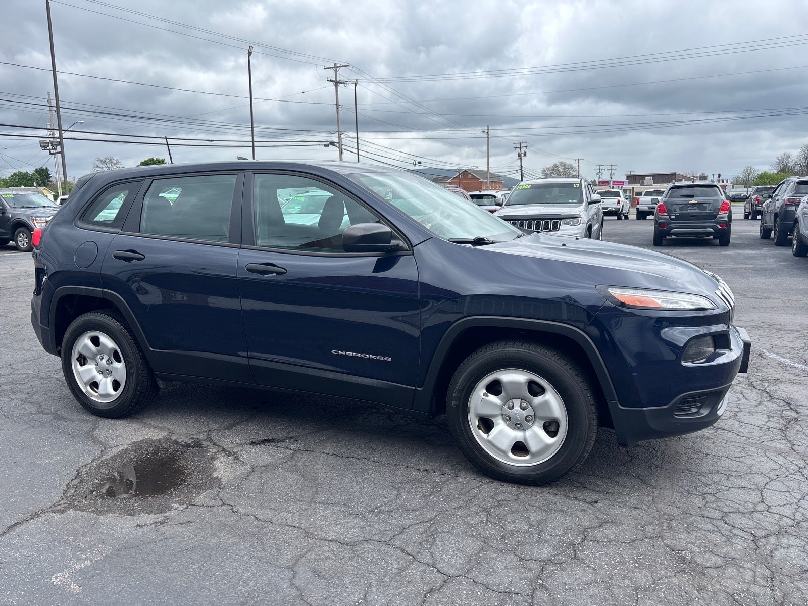 2016 Jeep Cherokee Sport in True Blue Pearl Coat — front three-quarter view