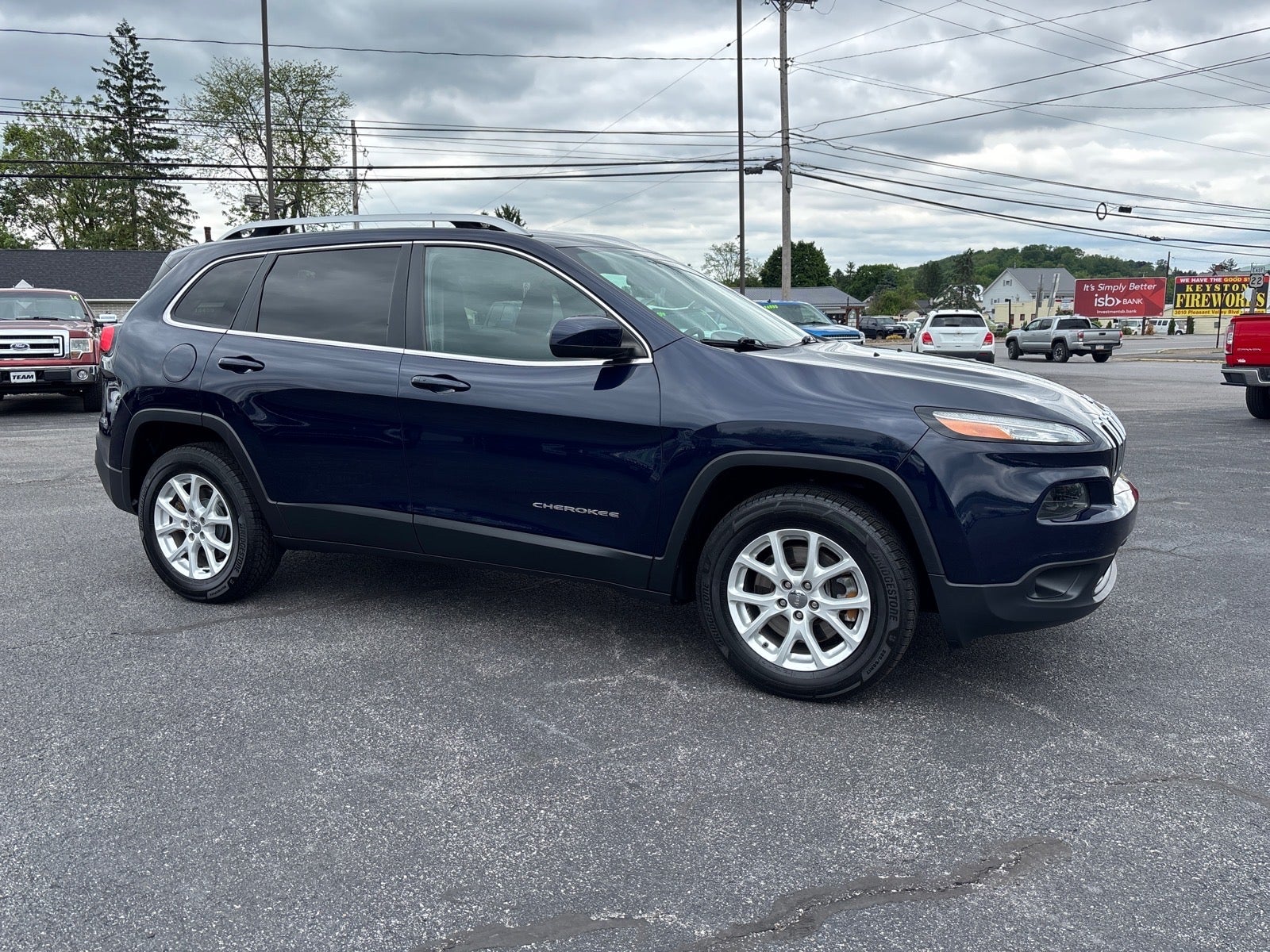 2016 Jeep Cherokee Latitude in True Blue Pearl Coat — front three-quarter view