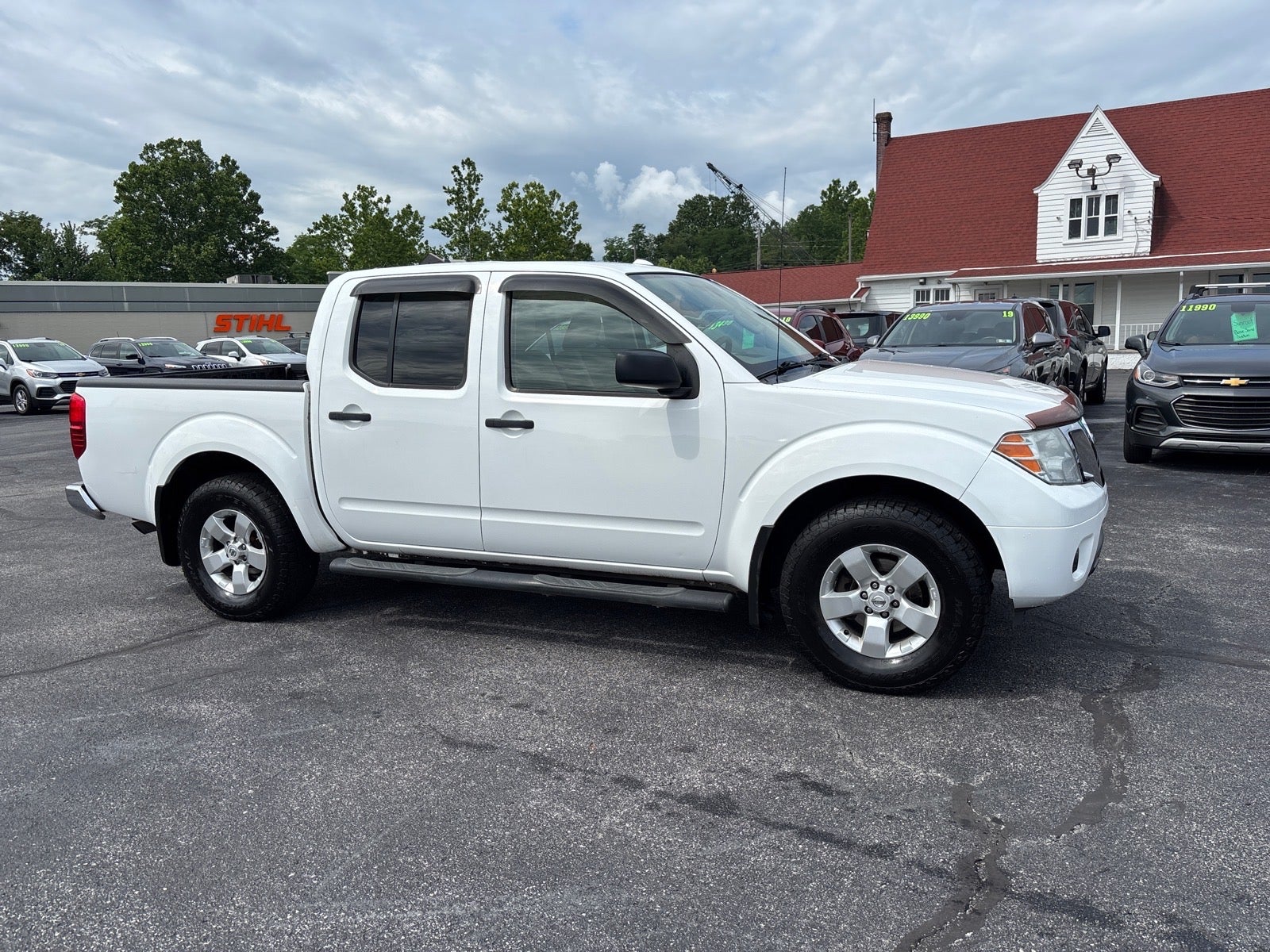 2012 Nissan Frontier SV V6 in Avalanche — front three-quarter view